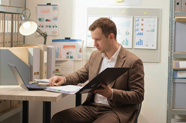 Procurement professional managing documents and reports